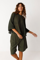 SKFK Damen Top in Dunkelgrün mit halbrundem Schnitt und 3/4-Ärmeln aus kontrastierendem Stoff – aus 100% recyceltem Polyester, erhältlich bei Youmee.market Schweiz